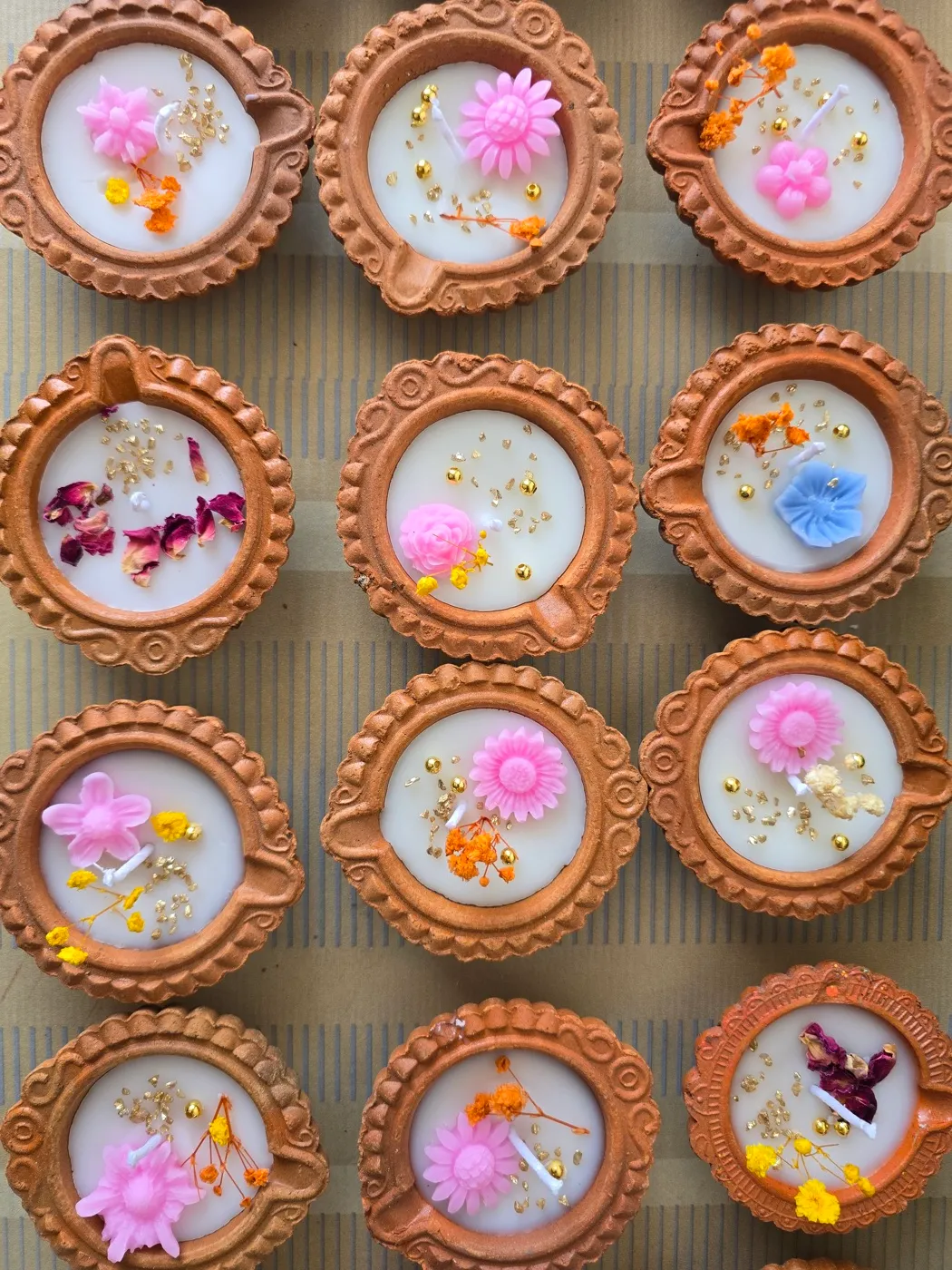 A batch of floral diyas being finished