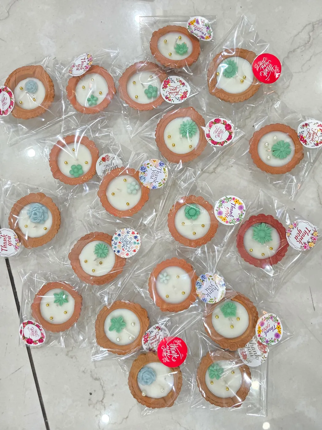 Floral diyas wrapped individually as wedding favours