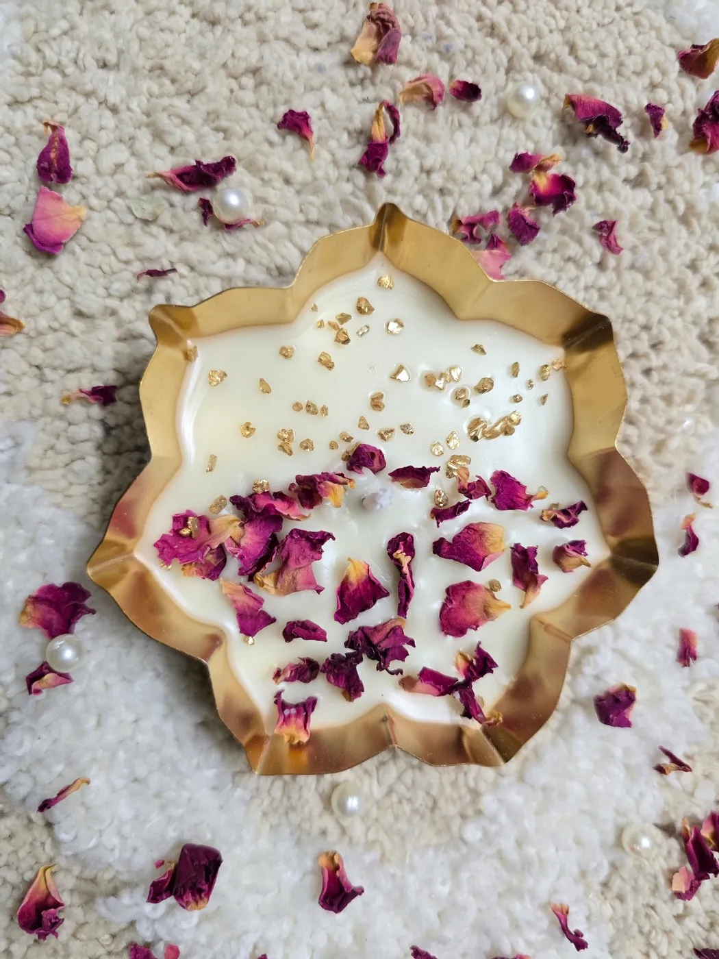 An urli candle with rose petals